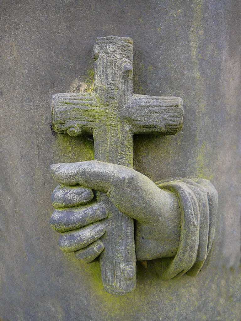 Stone hand with cross